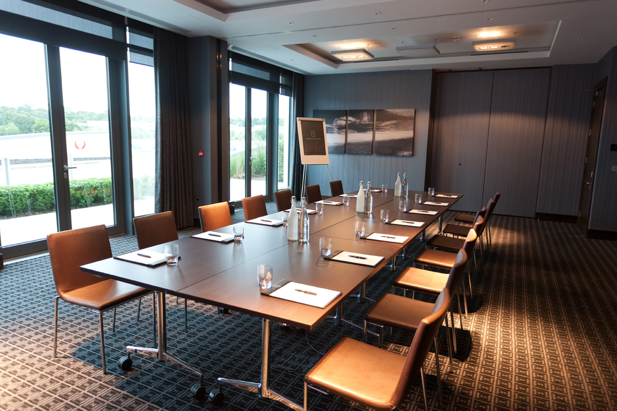 Modern meeting room with boardroom table and presentation screen